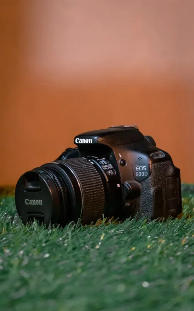black nikon dslr camera on green grass