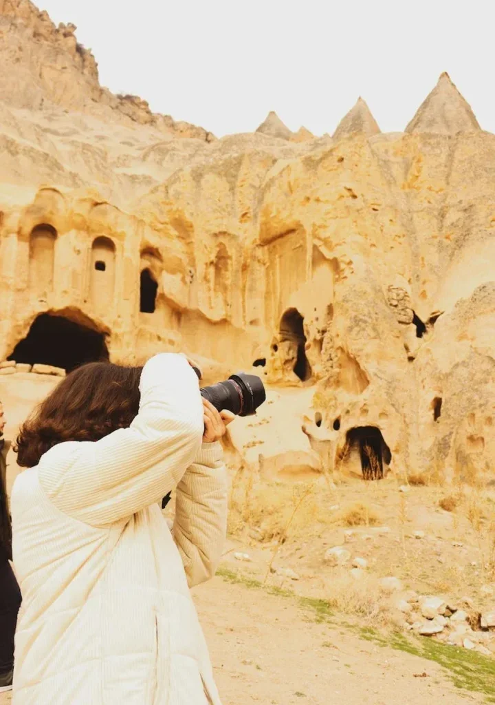 man taking photos of ancient buildings