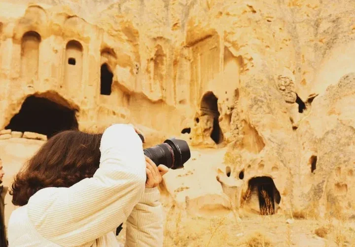 man taking photos of ancient buildings