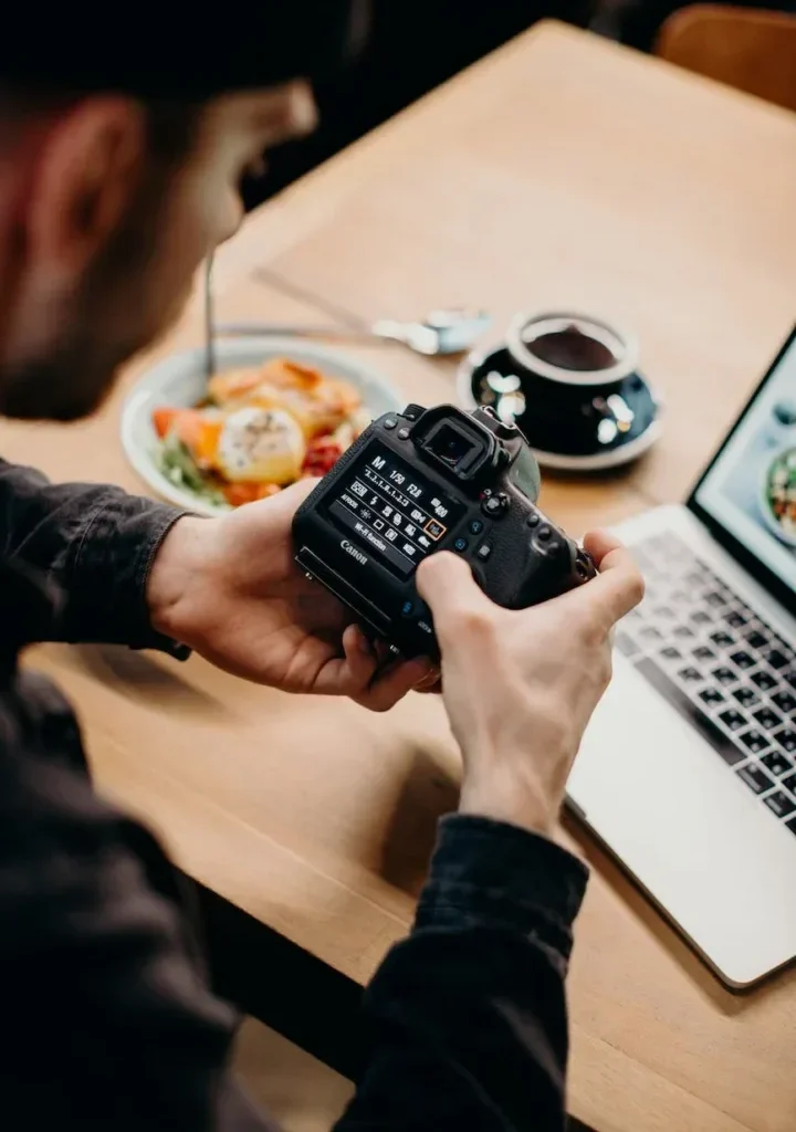 selective focus photography of man using black dslr camera