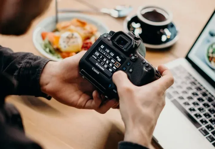 selective focus photography of man using black dslr camera
