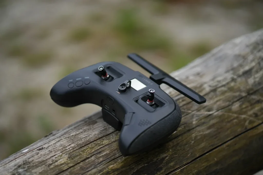 a video game controller sitting on top of a wooden table