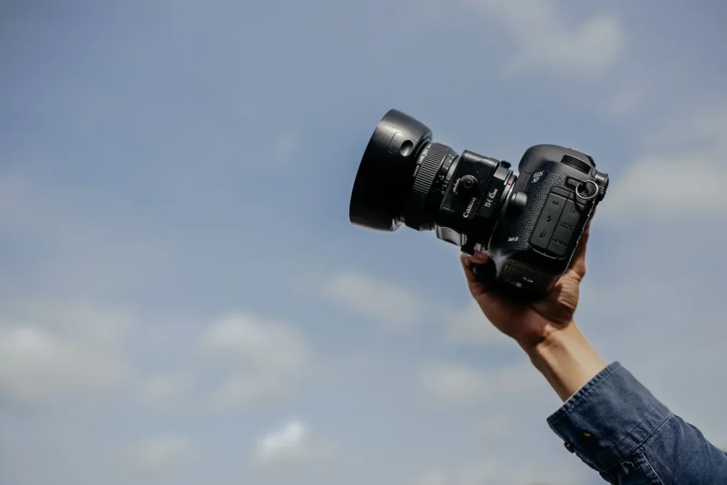 man using his black DSLR camera