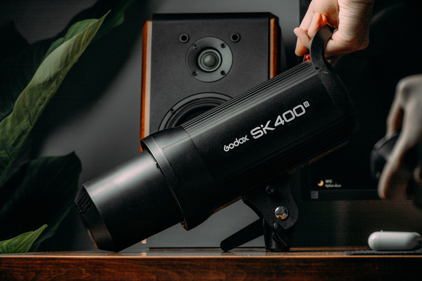 a person is holding a light on a desk