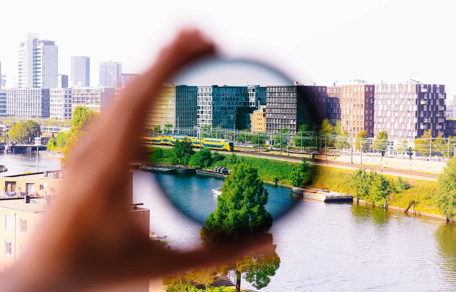 a person holding a magnifying glass over a river